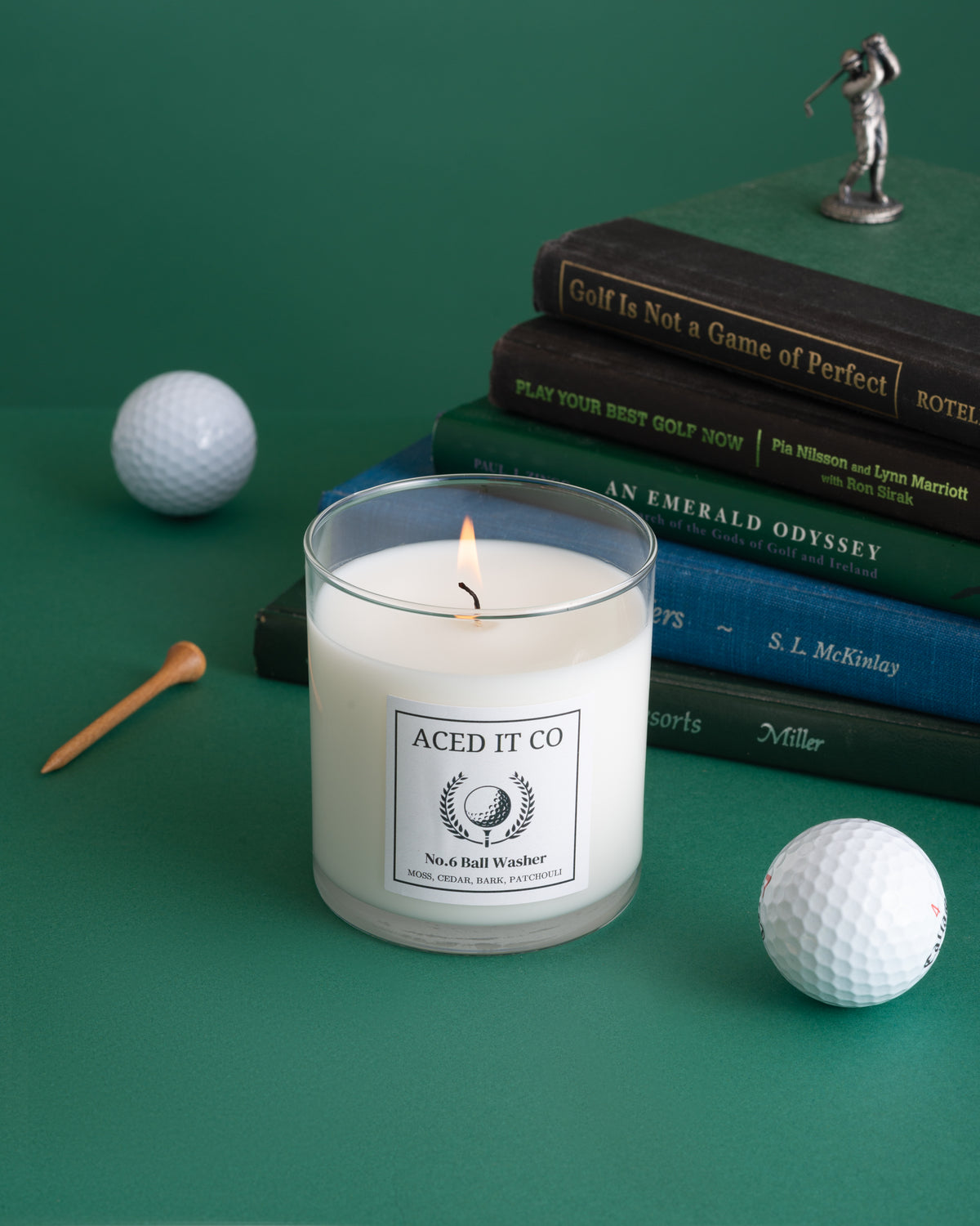 Ball Washer scented golf candle by Aced It Co., featuring red cedar, woody moss, and patchouli fragrance notes.
