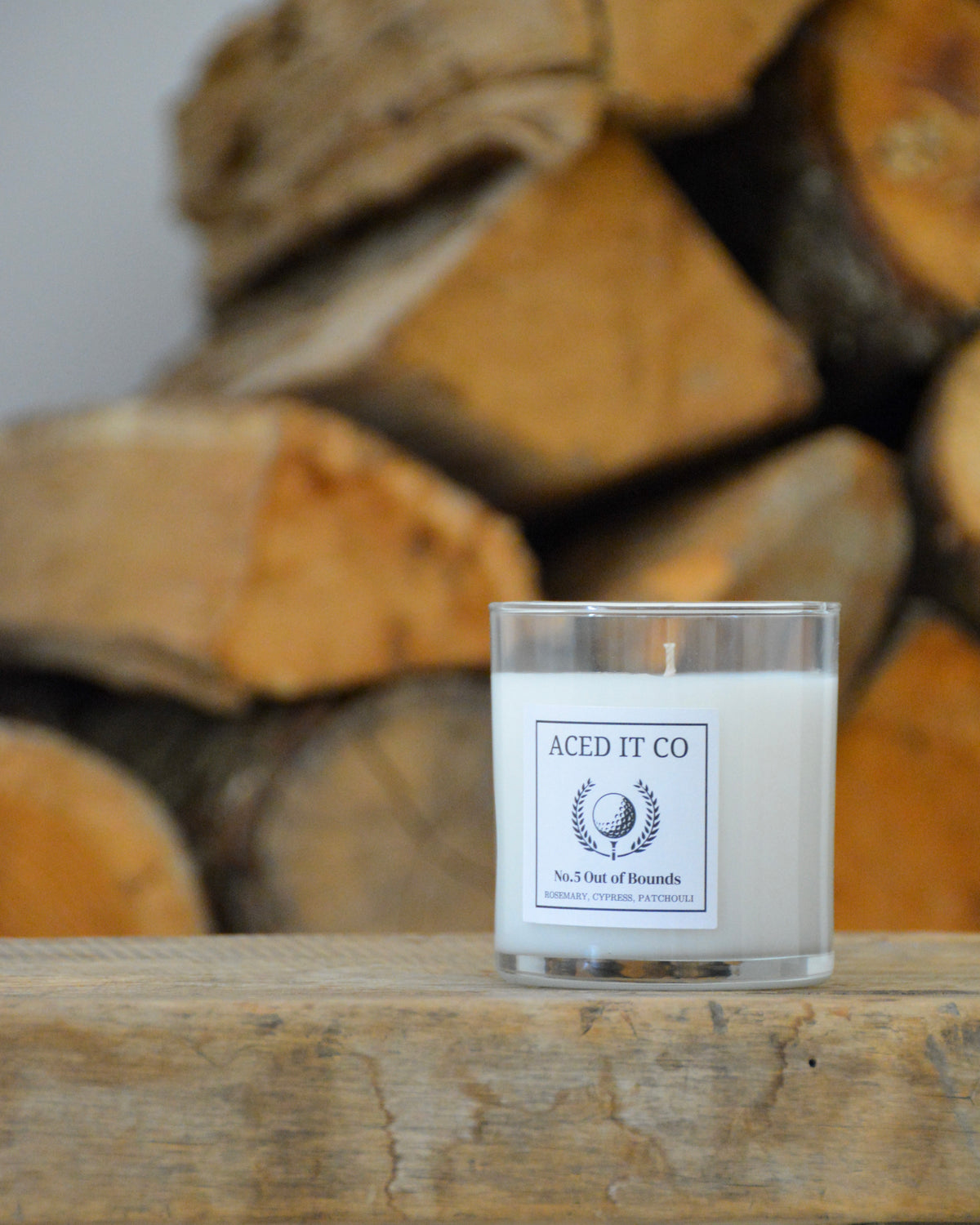 Out of Bounds scented golf candle by Aced It Co., inspired by woodland aromas of cypress, cedar, and rosemary.