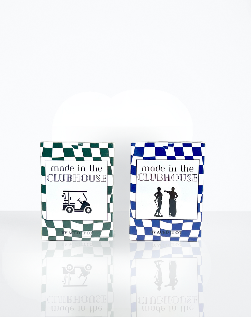 Two decks of playing cards with golf-themed designs, titled 'made in the clubhouse' on a checkered blue and white background.