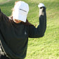 Aced It Co. Golf Is Therapy baseball cap, designed for everyday wear on and off the golf course. modeled by a female golfer
