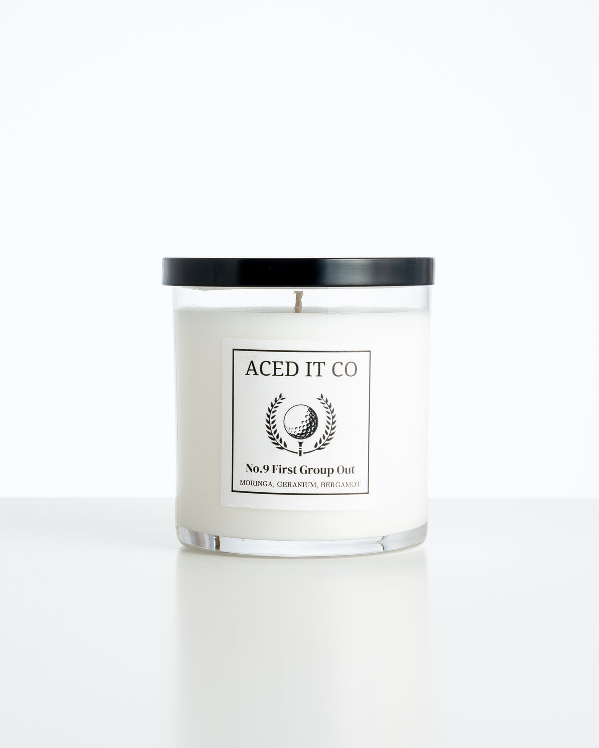 Aced It Co. First Group Out golf-inspired scented candle with a yellow golf ball label.