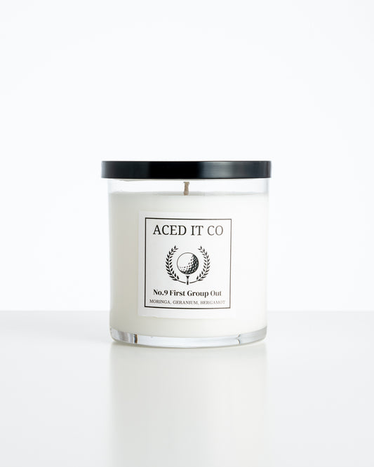 Aced It Co. First Group Out golf-inspired scented candle with a yellow golf ball label.
