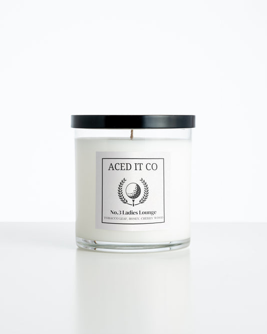 Aced It Co. Ladies Lounge golf-inspired candle with a golf ball label.