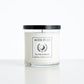 Aced It Co. Out of Bounds golf-inspired candle in a glass jar with an orange golf ball label.